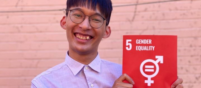 Man holding sign that says "5 Gender Equality"